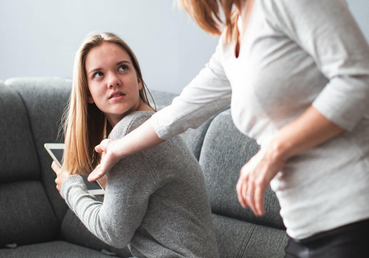 Screen time fight - teenage daughter unhappy about her mother limiting her screen time on a tablet computer